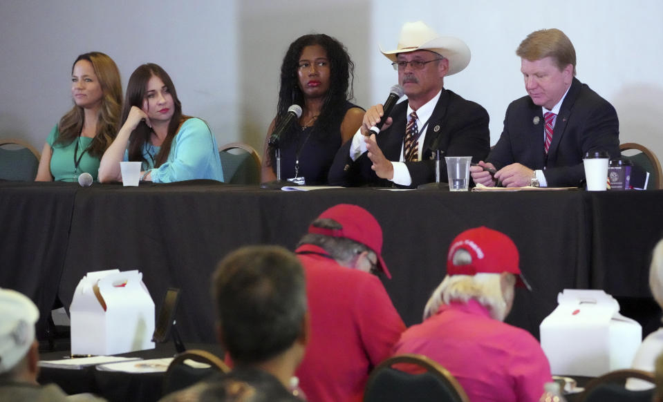 FILE - From left, Rachel Hamm, former California Secretary of State candidate, Audrey Trujillo, candidate for New Mexico Secretary of State, Kristina Karamo, candidate for Michigan Secretary of State, Mark Finchem, candidate for Arizona Secretary of State and Jim Marchant, candidate for Nevada Secretary of State, attend a conference promoting conspiracy theories about voting machines and discredited claims about the 2020 presidential election at a hotel in West Palm Beach, Fla., Sept. 10, 2022. (AP Photo/Jim Rassol, File)