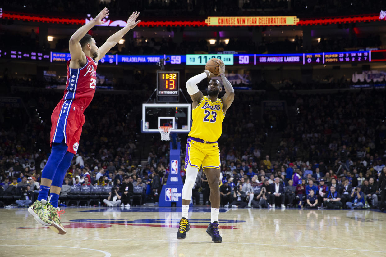 LeBron James #23 of the Los Angeles Lakers shoots the ball against Ben Simmons #25 of the Philadelphia 76ers at the Wells Fargo Center.