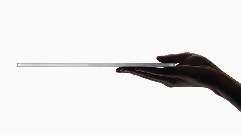 A hand holding an iPad Pro