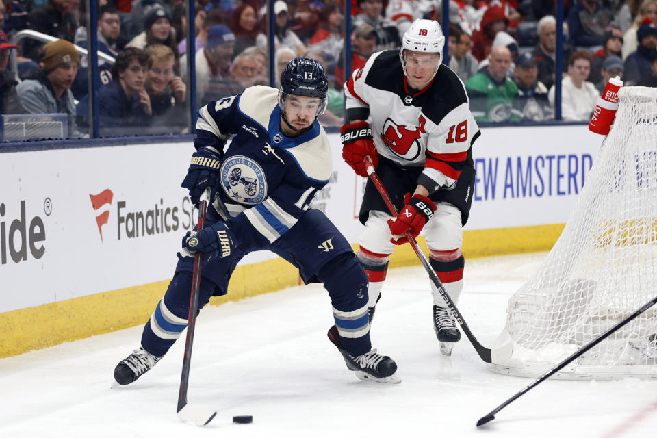 Columbus Blue Jackets forward Johnny Gaudreau, left, controls the puck in front of New Jersey Devils forward Ondrej Palat, right, during the second period an NHL hockey game in Columbus, Ohio, Saturday, Dec. 16, 2023. (AP Photo/Paul Vernon)