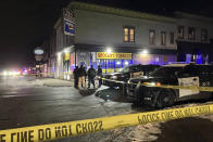 Law enforcement at Hudson Road and Earl Street in St. Paul, Minn., after St. Paul police shot a person on Monday, Dec. 5, 2022. A police officer in Minnesota fatally shot a man who authorities say displayed a handgun as officers were trying to arrest him, the St. Paul Police Department said Tuesday. (Nick Woltman/Pioneer Press via AP)