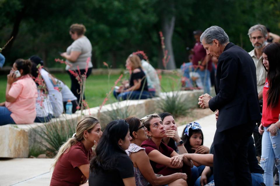 The Archbishop of San Antonio, Gustavo Garcia-Siller, right, comforts families outside of the Civic Center following a deadly school shooting at Robb Elementary School, in Uvalde, Texas Tuesday, May 24, 2022.