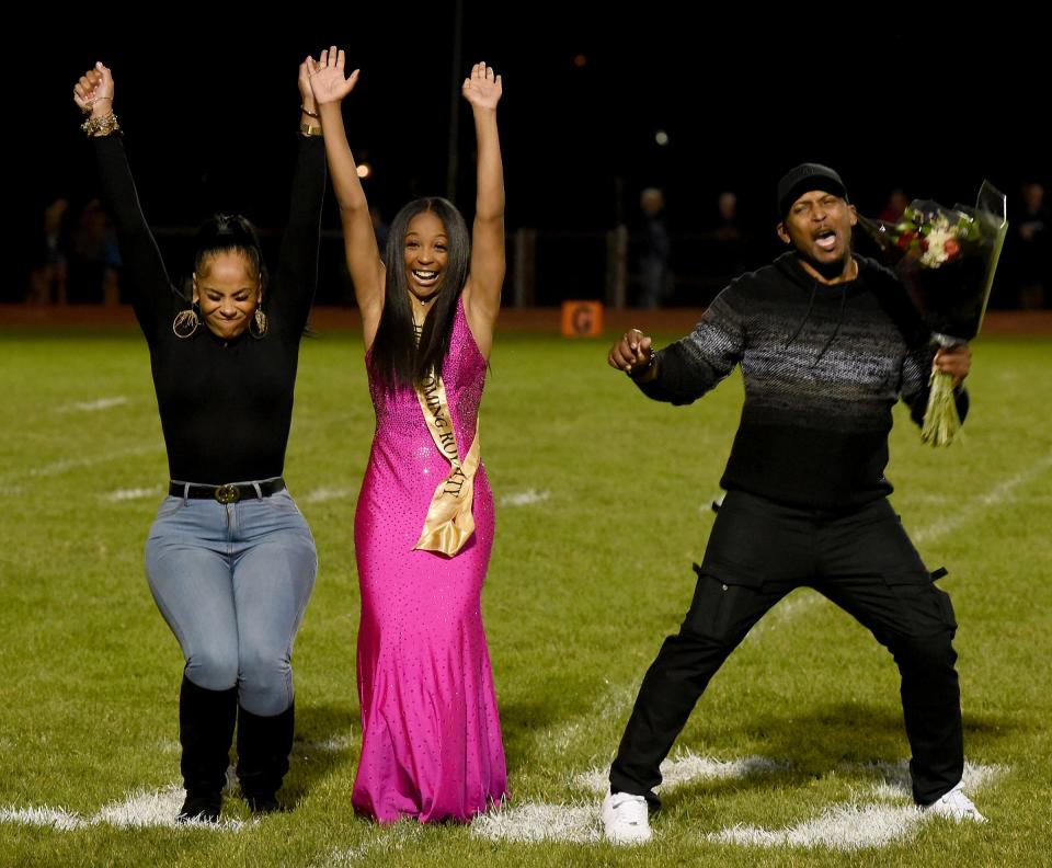 Monroe High School senior Vannity Anderson shows her excitement with her parents Amber Ford and Raymond Anderson as she was announced homecoming queen Friday, October 1, 2021.
