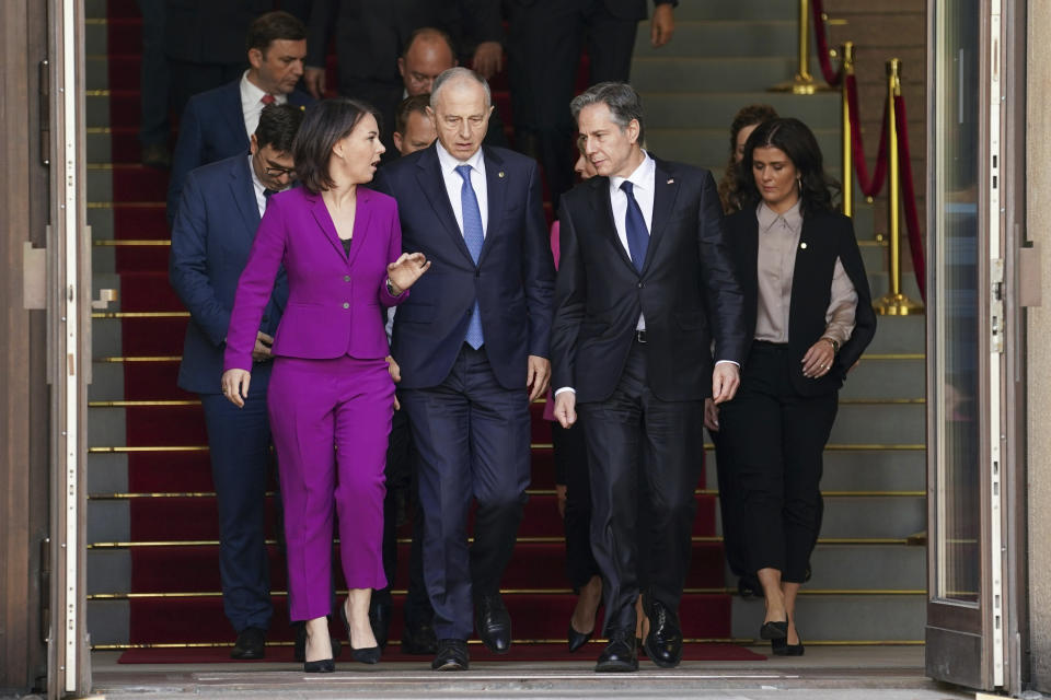 German Foreign Minister Annalena Baerbock, left, NATO Deputy Secretary General Mircea Geoana, second left, and U.S. Secretary of State Antony Blinken, second right, arrive for the group photo at the Informal Meeting of NATO Ministers of Foreign Affair in Berlin, Germany, Sunday May 15, 2022. (Kevin Lamarque/Pool via AP)