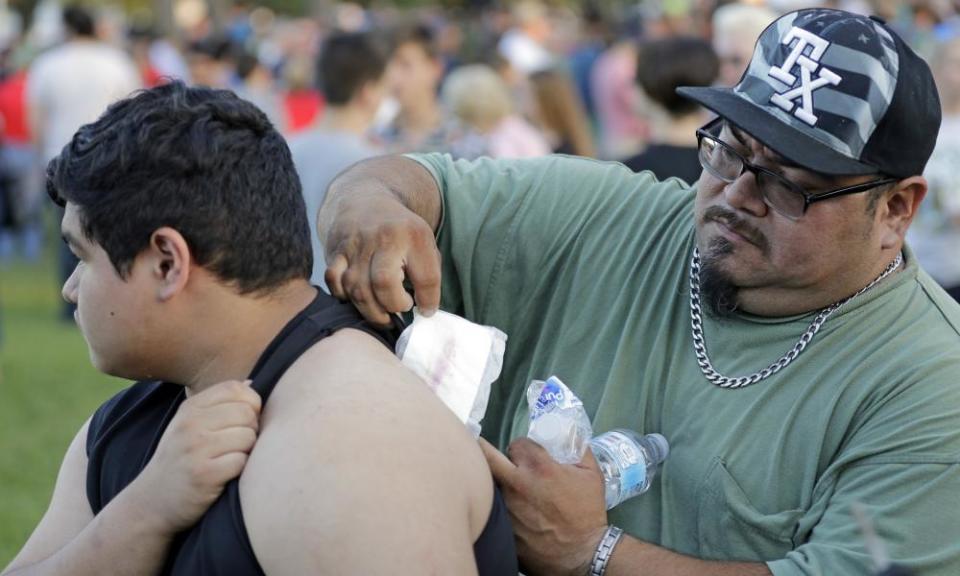 Gabriel San Miguel removes a bandage from his son’s back. Abel San Miguel was inside a classroom when the Santa Fe gunman opened fire