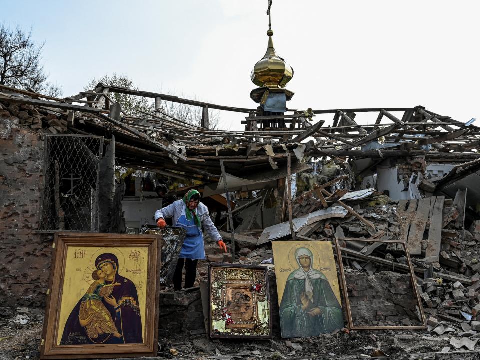 A woman collects Orthodox icons at a site of a church destroyed by a Russian missile strike, amid Russia's attack on Ukraine, in the village of Komyshuvakha, Zaporizhzhia region, Ukraine (REUTERS)