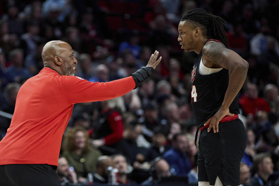 Portland Trail Blazers coach Chauncey Billups talks to forward Jabari Walker during the first half of the team's NBA basketball game against the Los Angeles Clippers in Portland, Ore., Wednesday, March 20, 2024. (AP Photo/Craig Mitchelldyer)