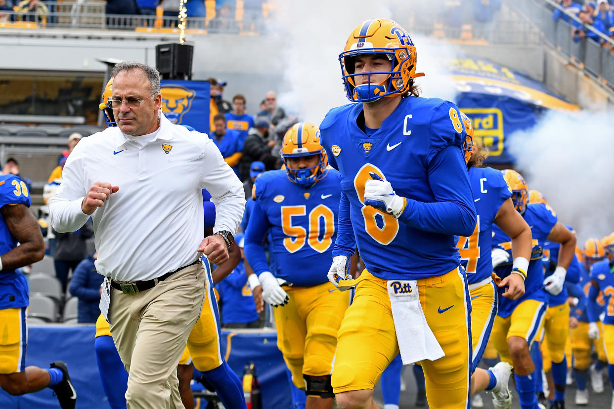 PITTSBURGH, PA - OCTOBER 30: Kenny Pickett #8 of the Pittsburgh Panthers and head coach Pat Narduzzi take the field before the game against the Miami Hurricanes at Heinz Field on October 30, 2021 in Pittsburgh, Pennsylvania. (Photo by Justin Berl/Getty Images)