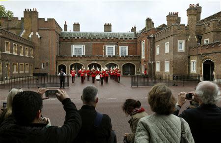 Royal fans wait outside St James's Palace before the christening of Prince George in London