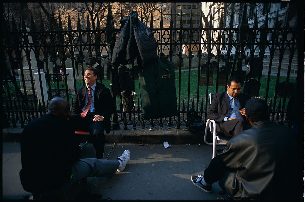 Two men having their shoes cleaned in New York