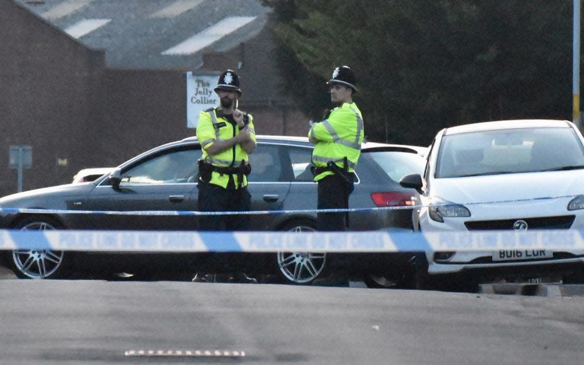 Police at the scene in Wolverhampton where a six-year-old boy was injured  - PA