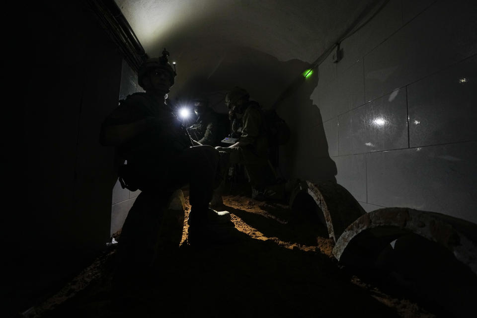 Israeli soldiers operate cameras inside a tunnel underneath UNRWA compound, where the military discovered tunnels in the main headquarters of the U.N. agency that the military says Hamas militants used to attack its forces during a ground operation in Gaza, Thursday, Feb. 8, 2024. The Israeli military says it has discovered tunnels underneath the main headquarters of the U.N. agency for Palestinian refugees in Gaza City, alleging that Hamas militants used the space as an electrical supply room. The unveiling of the tunnels marked the latest chapter in Israel's campaign against the embattled agency, which it accuses of collaborating with Hamas. (AP Photo/Ariel Schalit)