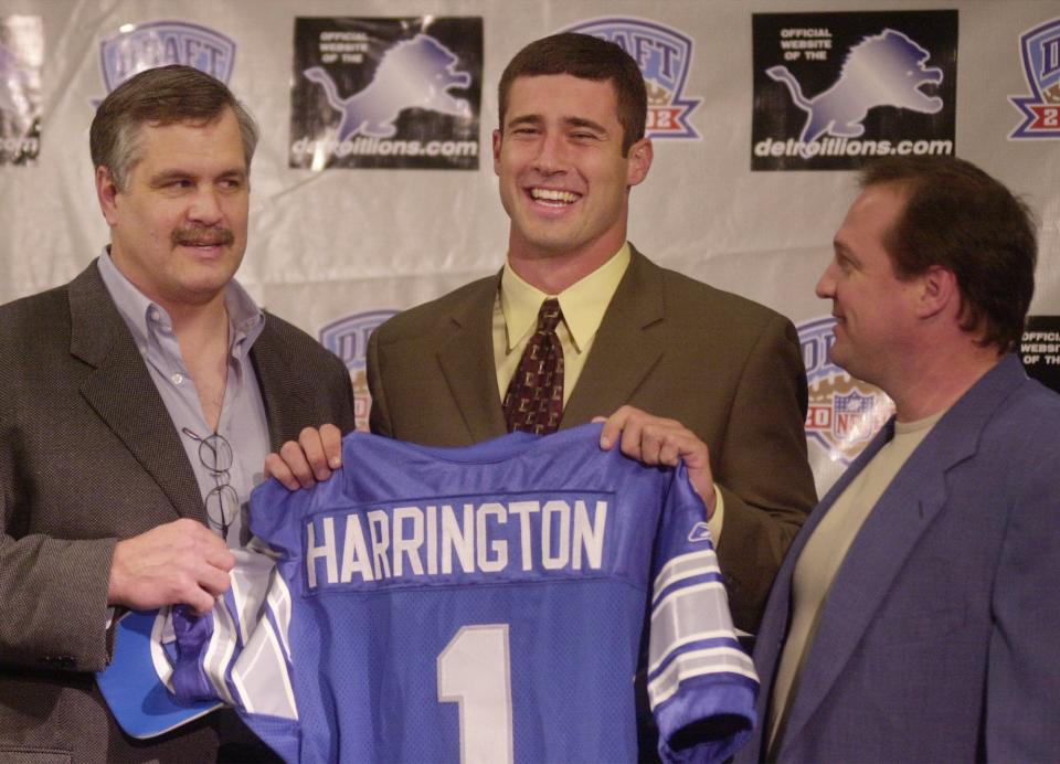 Lions president and chief executive officer Matt Millen, left, and coach Marty Mornhinweg, right, pose with the team's first-round draft pick, Oregon quarterback Joey Harrington, Sunday, April 21, 2002, at the Lions practice facility in Allen Park.