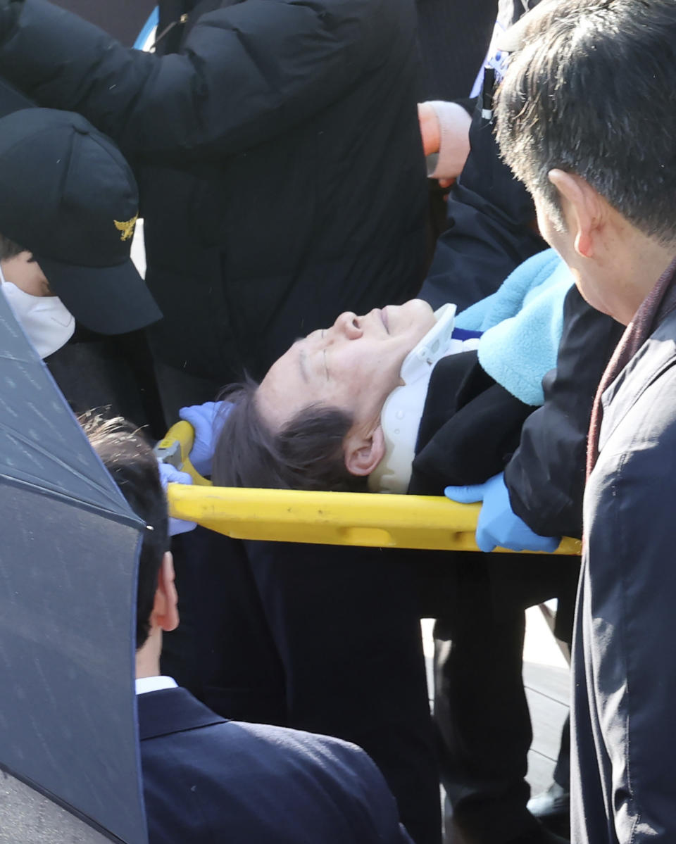 South Korean opposition leader Lee Jae-myung on a stretcher, is carried by rescue team in Busan, South Korea, Tuesday, Jan. 2, 2024. Lee was attacked and injured by an unidentified man during a visit Tuesday to the southeastern city of Busan, emergency officials said. (Ha Kyung-min/Newsis via AP)
