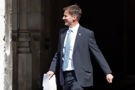 PM hopeful Jeremy Hunt walks near the Parliament grounds in London