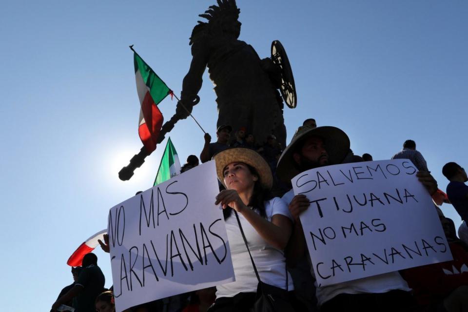 Demonstrators with signs that read in Spanish