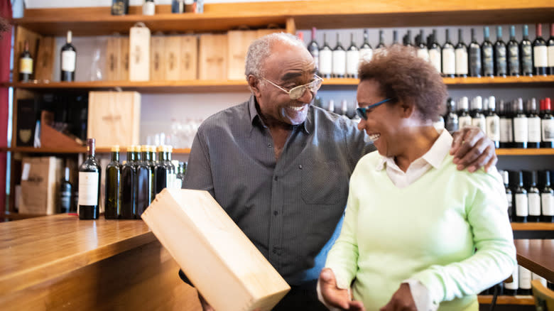 Couple holding a box of wine