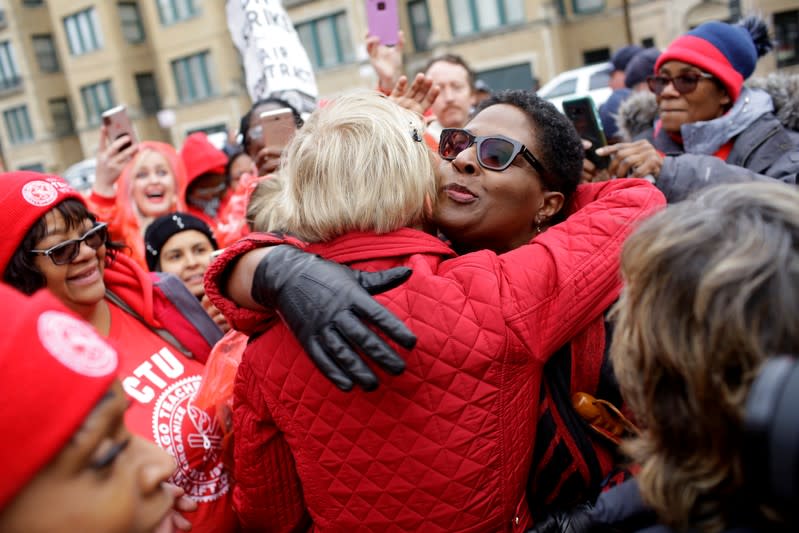 Democratic presidential candidate Senator Elizabeth Warren receives a hug as she visits a picket line of striking teachers in Chicago