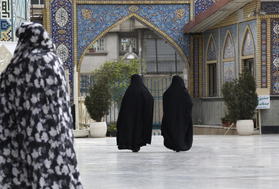 Head-to-toe veiled Iranian women walk at the shrine of Saint Saleh in northern Tehran, Iran, Tuesday, April 6, 2021. (AP Photo/Vahid Salemi)