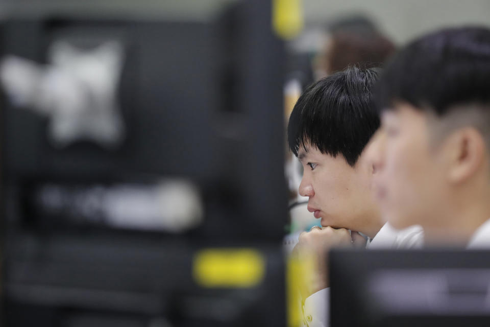 A currency trader watches computer monitors at the foreign exchange dealing room in Seoul, South Korea, Thursday, Nov. 7, 2019. Asian stocks are mostly lower after a meandering day of trading left U.S. stock indexes close to their record highs. (AP Photo/Lee Jin-man)