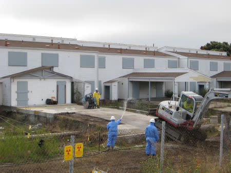 Workers remove a radioactive hotspot under the carport of an unoccupied home on Westside Drive on Treasure Island, near San Francisco, California U.S., in this June 2009 handout photo. Handout via REUTERS