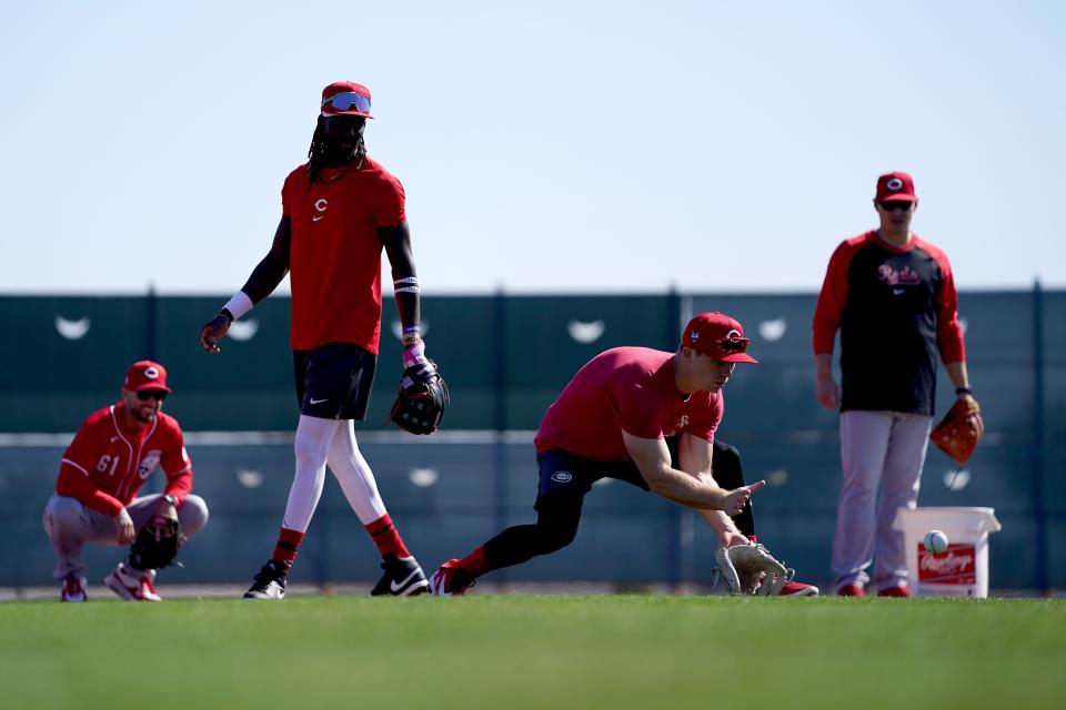 Cincinnati Reds shortstop Matt McLain (9) fields groundballs with Cincinnati Reds third baseman Elly De La Cruz (44) during spring training workouts, Wednesday, Feb. 14, 2024, at the team’s spring training facility in Goodyear, Ariz.