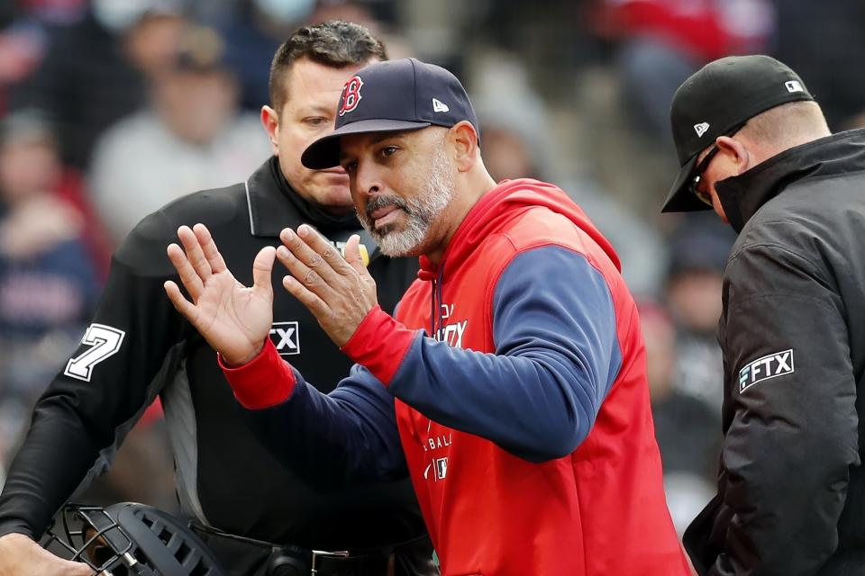 Boston Red Sox manager Alex Cora, center, argues with home plate umpire Carlos Torres, left, after being ejected during the third inning of a baseball game against the Chicago White Sox, Saturday, May 7, 2022, in Boston. (AP Photo/Michael Dwyer)