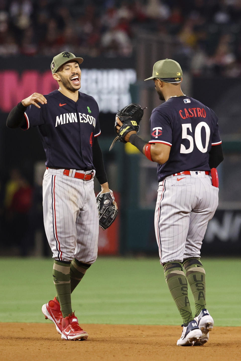 Minnesota Twins shortstop Carlos Correa (4) and second baseman Willi Castro (50) celebrate after defeating the Los Angeles Angels 6-2 during a baseball game in Anaheim, Calif., Saturday, May 20, 2023. (AP Photo/Jessie Alcheh)