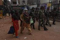 Indian security officers patrol a street in New Delhi, India, Wednesday, Feb. 26, 2020. At least 20 people were killed in three days of clashes in New Delhi, with the death toll expected to rise as hospitals were overflowed with dozens of injured people, authorities said Wednesday. The clashes between Hindu mobs and Muslims protesting a contentious new citizenship law that fast-tracks naturalization for foreign-born religious minorities of all major faiths in South Asia except Islam escalated Tuesday. (AP Photo/Rajesh Kumar Singh)