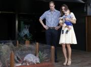 Britain's Kate, the Duchess of Cambridge, and her husband Britain's Prince William, watch as their son Prince George looks at an Australian animal called a Bilby, which has been named after the young prince, during a visit to Sydney's Taronga Zoo, Australia Sunday, April 20, 2014. (AP Photo/David Gray, Pool)