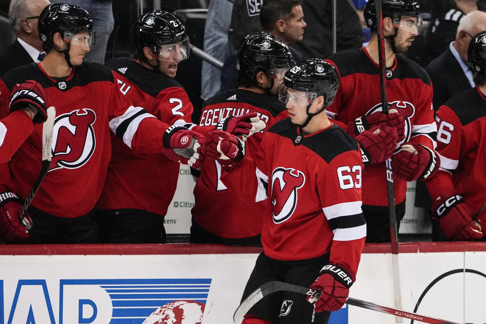 New Jersey Devils' Jesper Bratt (63) is congratulated for his goal against the New York Rangers during the first period of an NHL preseason hockey game Wednesday, Oct. 4, 2023, in Newark, N.J. (AP Photo/Frank Franklin II)