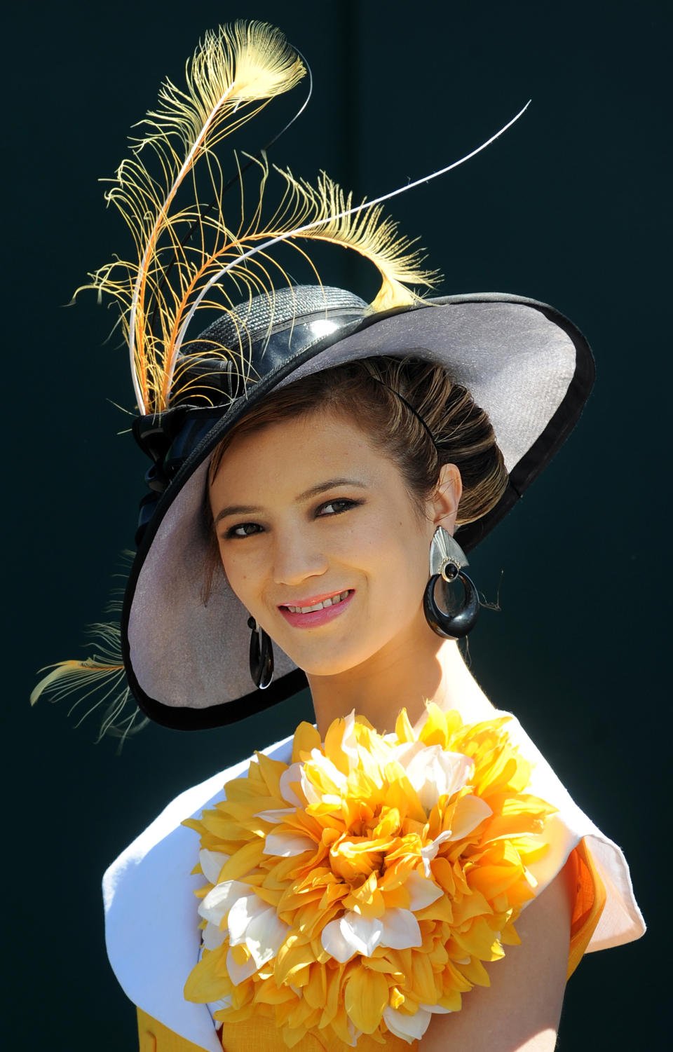 A racegoer poses for photographers on 'Ladies Day' on the first day of the Epsom Derby Festival in Surrey, southern England, on June 3, 2011. The Epsom Derby race will be run Saturday June 4, 2011.  AFP PHOTO / BEN STANSALL (Photo credit should read BEN STANSALL/AFP/Getty Images)