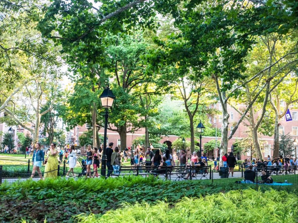New York University students walk through Manhattan’s  Washington Square Park in Greenwich Village (Getty Images)