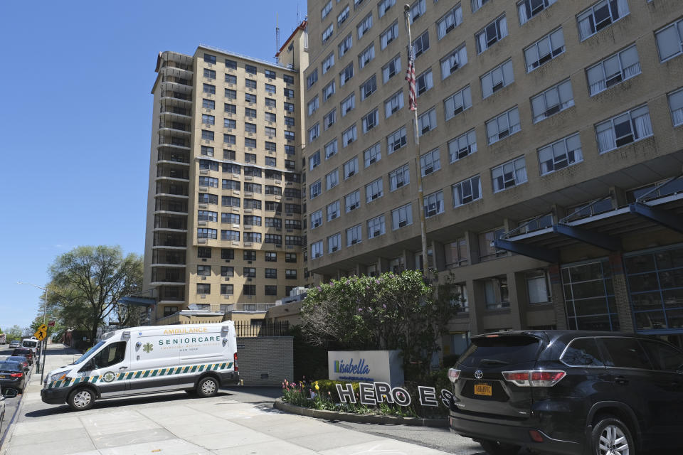 FILE - In this May 5, 2020, file photo an ambulance leaves the Isabella Center in New York. A report from Senate Democrats finds that the Trump administration was slow to comprehend the scale of COVID-19's impact on nursing homes and a disjointed federal response only compounded the devastating toll. (AP Photo/Seth Wenig, File)