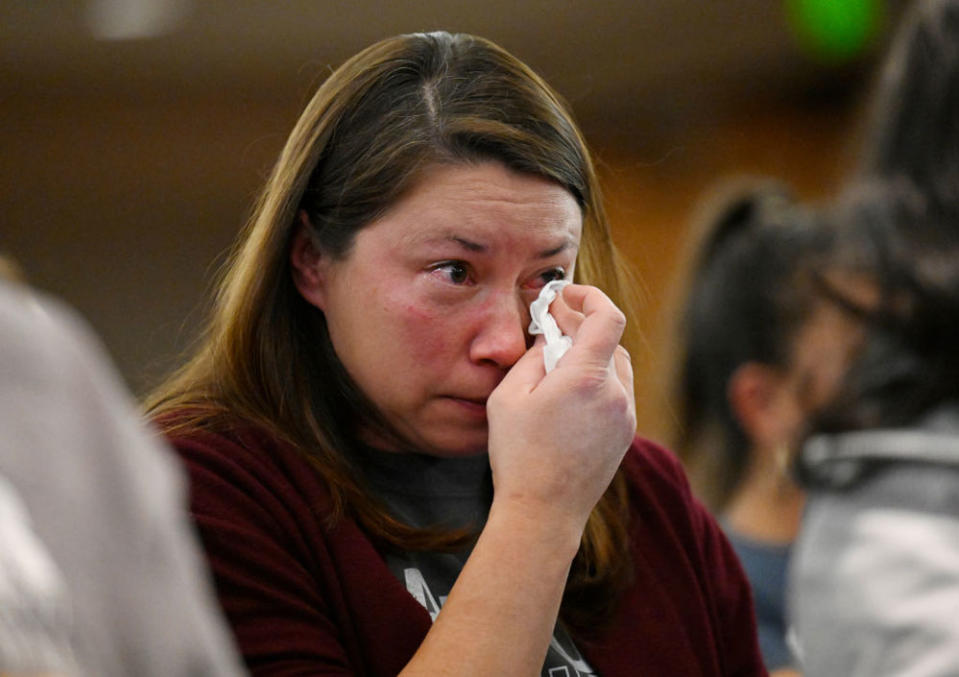 Alanna Ritchie, whose child attended one of the 16 closed schools, dabbed tears during the November 2022 meeting when the school board voted. (Getty Images)