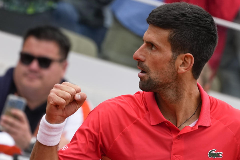 Serbia's Novak Djokovic celebrates his win against Argentina's Diego Schwartzman in three sets, 6-1, 6-3, 6-3, in their fourth round match at the French Open tennis tournament in Roland Garros stadium in Paris, France, Sunday, May 29, 2022. (AP Photo/Michel Euler)