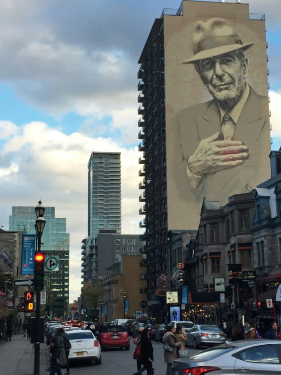 A mural of the late Canadian singer-songwriter Leonard Cohen is seen over a street in Montreal, Canada, before artists gathered for a tribute concert marking one year since his death