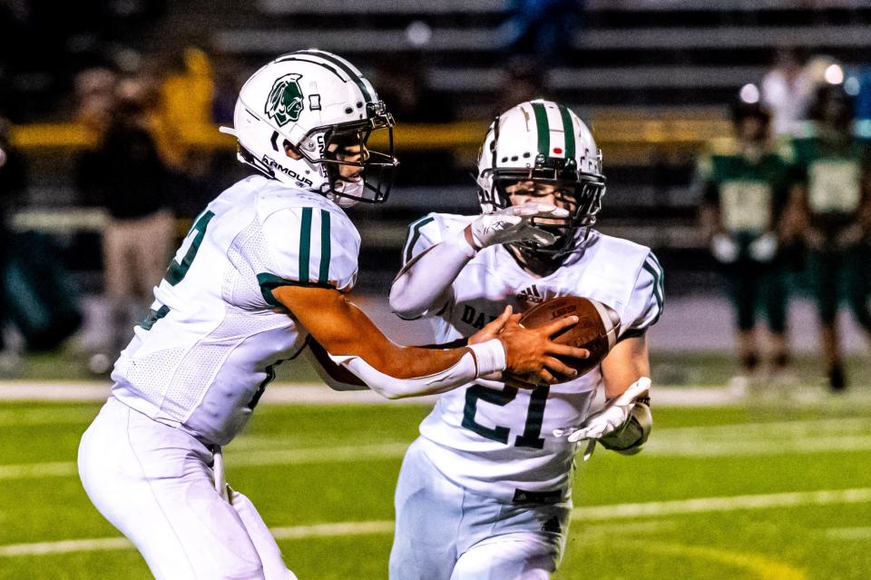 Dartmouth's Jackson Hart hands the ball off to Ray Gramlich.