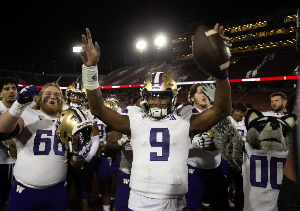 Oct 28, 2023; Stanford, California, USA; Washington Huskies quarterback Michael Penix Jr. (9) and his teammates celebrate their victory over the Stanford Cardinal at Stanford Stadium. Mandatory Credit: D. Ross Cameron-USA TODAY Sports