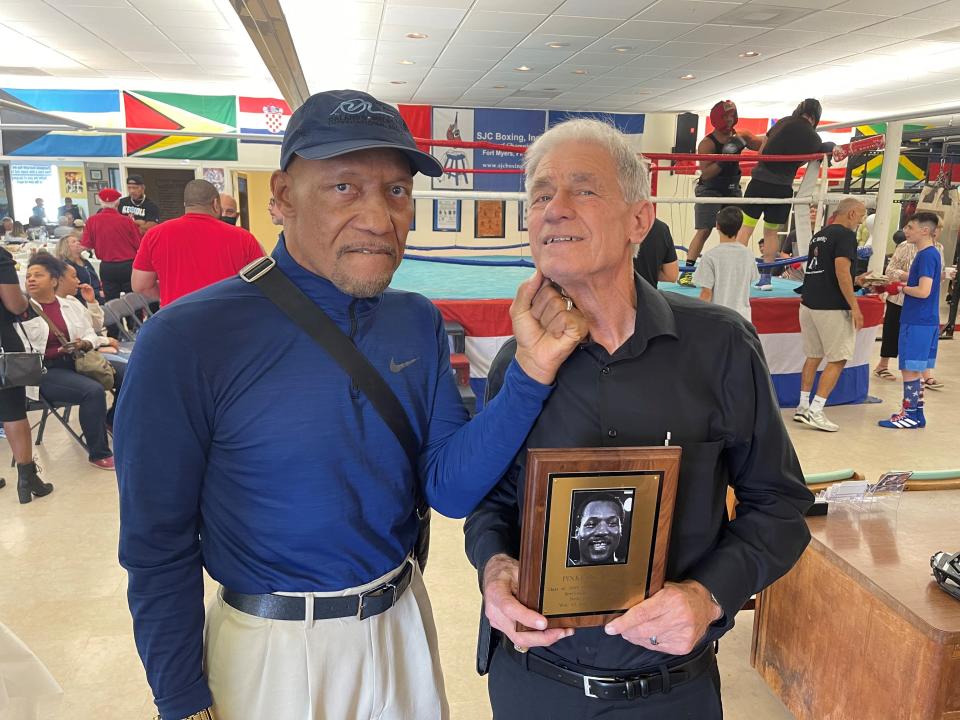 Boxing trainer Steve Canton (right) poses with two-time heavyweight champion Pinklon Thomas at Canton's SJC Boxing gym in Fort Myers.  Thomas is a big supporter of SJC and its mission to mentor kids.