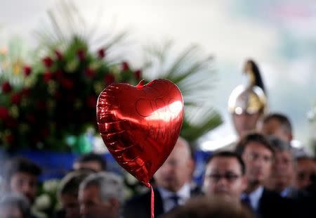 A heart-shaped balloon is seen during a funeral service for victims of the earthquake that levelled the town in Amatrice, central Italy, August 30, 2016. REUTERS/Max Rossi