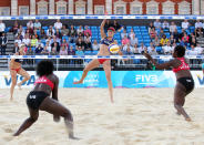 LONDON, ENGLAND - AUGUST 09: April Ross of the USA smashes a shot past the team from Uganda during the VISA FIVB Beach Volleyball International at Horse Guards Parade on August 9, 2011 in London, England. (Photo by Scott Heavey/Getty Images)