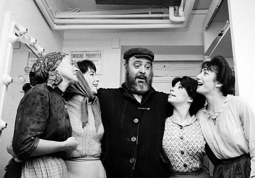 Actor Zero Mostel, center, who portrays Tevye in the musical "Fiddler on the Roof," poses backstage with cast members after the play's opening performance at the Imperial Theatre in New York City on Sept. 22, 1964. Maria Karnilova, who plays Tevye's wife, Golde, is at far left. Playing Tevye's daughters, from left, are, Tanya Everett, as Chava; Julia Migenes, as Hodel; and Joanna Merlin, as Tzeitel.