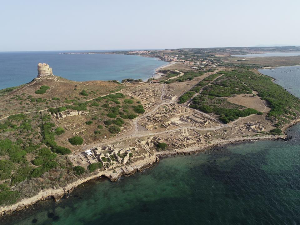 A bird's-eye view of Tharros, an archaeological site located on the Mediterranean Sea.