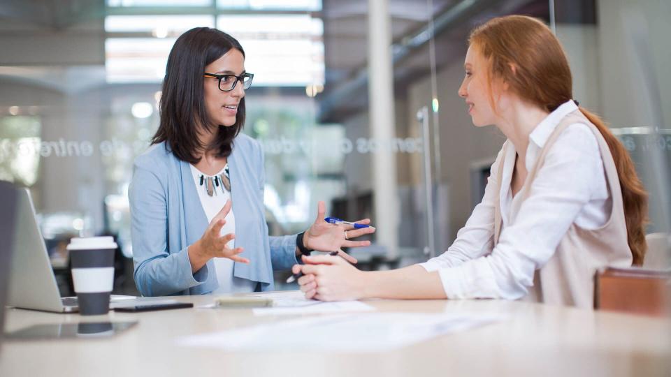 Coaching, two business women working together