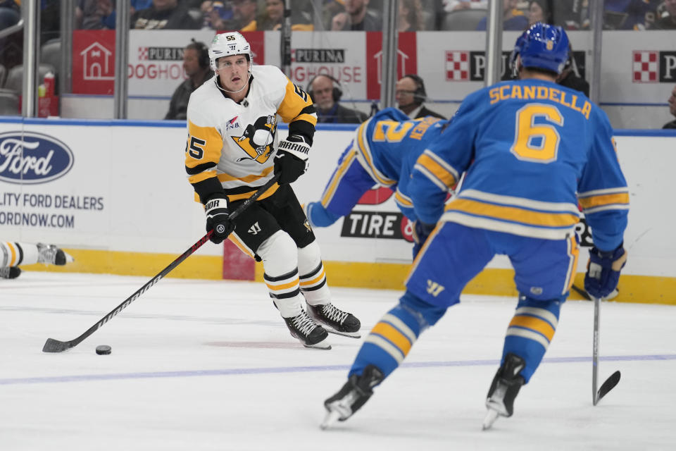 Pittsburgh Penguins' Noel Acciari (55) brings the puck down the ice as St. Louis Blues' Marco Scandella (6) defends during the first period of an NHL hockey game Saturday, Oct. 21, 2023, in St. Louis. (AP Photo/Jeff Roberson)