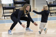 North Carolina head coach Courtney Banghart reaches to hug her son Tucker, 6, following an NCAA college basketball game against North Carolina State in Chapel Hill, N.C., Sunday, Feb. 7, 2021. (AP Photo/Gerry Broome)