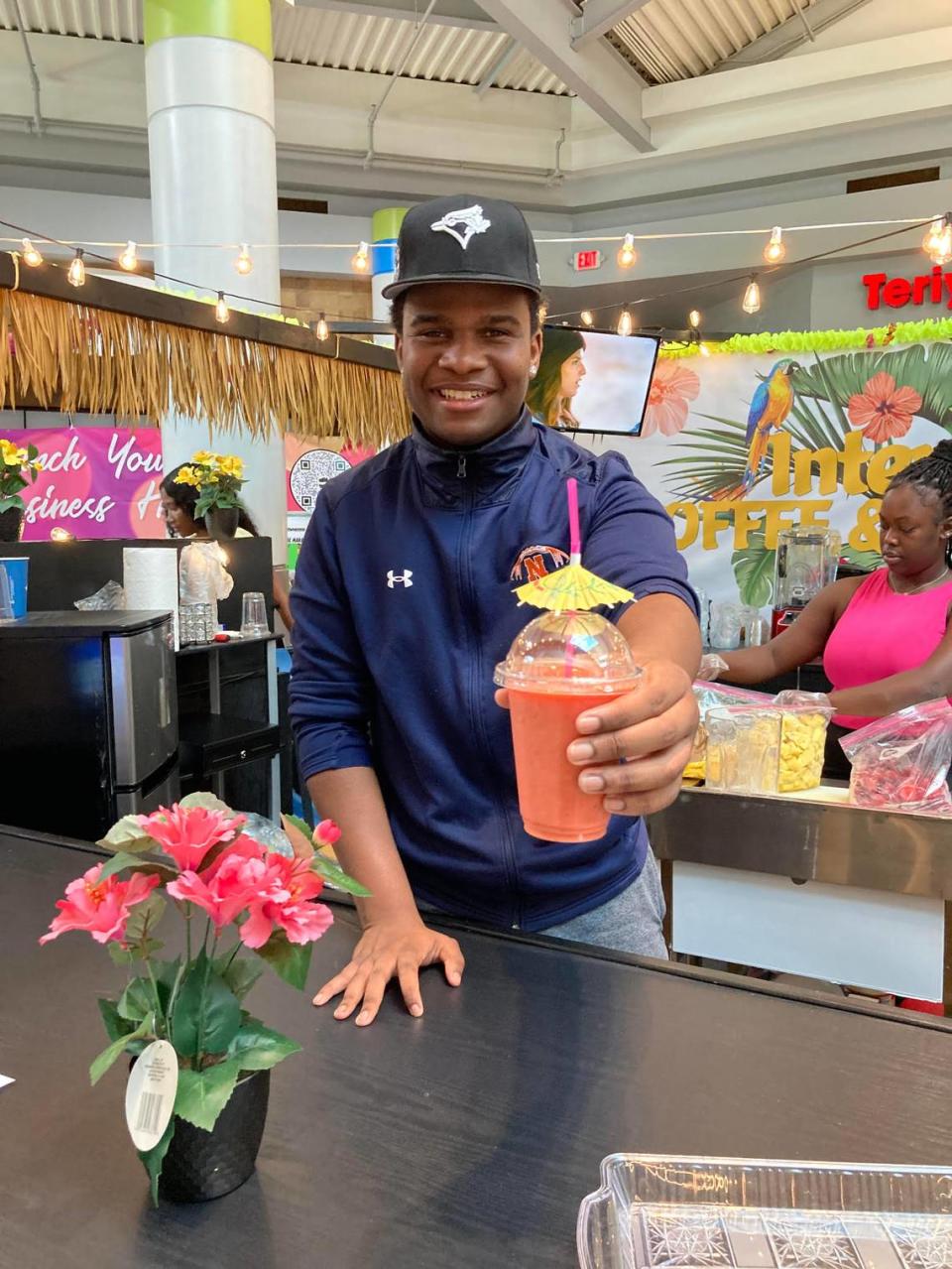 Jaylen Covington serves up a mango smoothie at the new International Coffee Shop and Smoothie Bar inside the Houston County Galleria in Centerville.