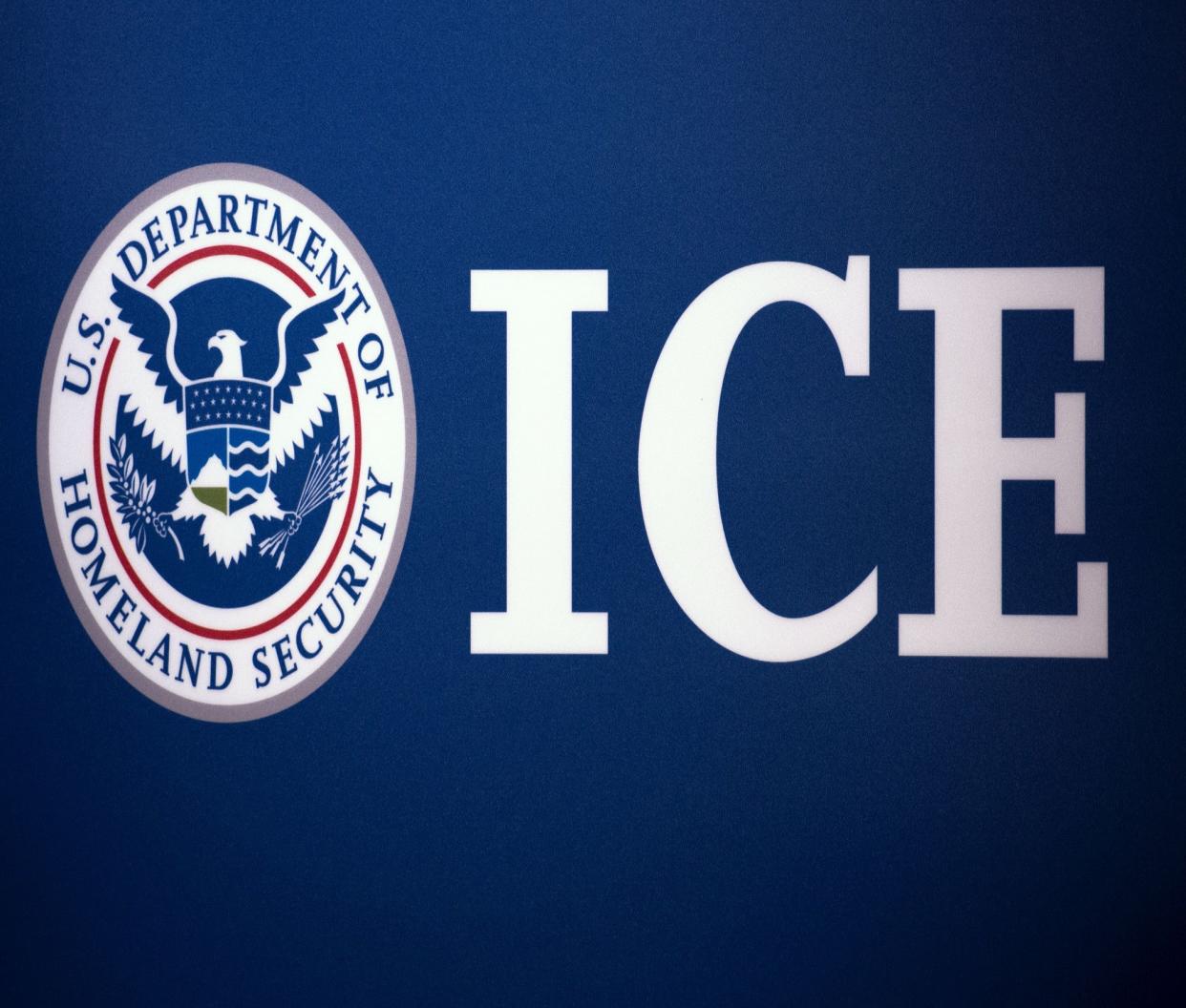 The Immigration and Customs Enforcement (ICE) seal is seen before a press conference discussing ongoing enforcement efforts to combat human smuggling along the Southwest border of the United States on 22 July 2014 at ICE headquarters in Washington, DC ((AFP via Getty Images))