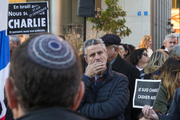 A French-Israeli dual national looks on during a remembrance ceremony in Tel Aviv on January 11, 2015 to protest against the Islamist attack in Paris